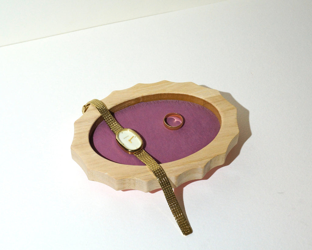 Lou The Label handmade oval jewelry tray featuring a natural wood frame with scalloped edges and mauve pink brushed linen lining, displaying a vintage gold wristwatch and gold ring.