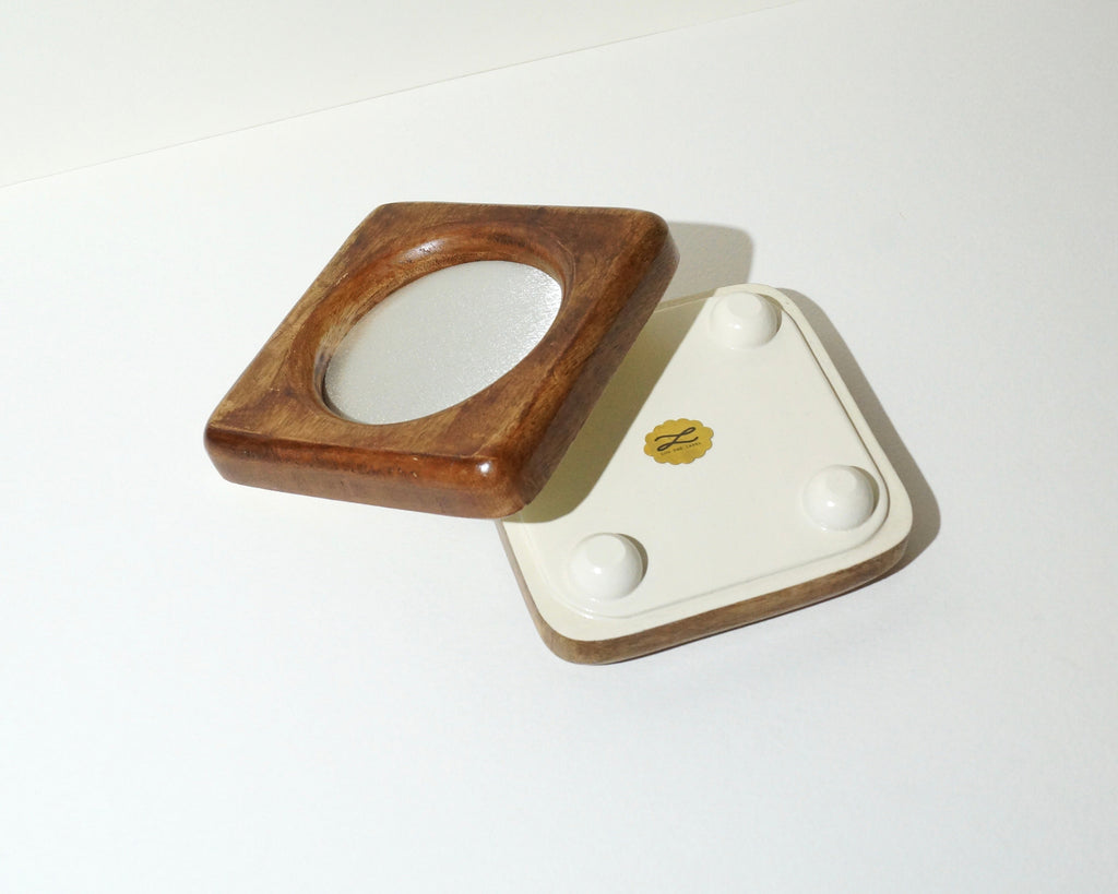 Handmade square wooden jewelry tray with a rich brown finish and ivory satin lining, shown alongside its cream-painted underside featuring four rounded feet and a gold Lou The Label emblem.