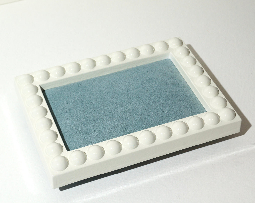 Handmade rectangular jewelry tray with a glossy ivory frame, raised rounded bubble detailing, and a soft dusty blue faux suede lining.